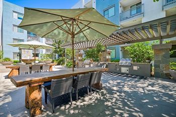 Mingle: courtyard with outdoor fireplace, water feature, and bbq grills